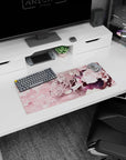 Schoolgirl leans into cherry blossoms, silver hair and navy pleated skirt on anime mouse pad 28x12 inches.
