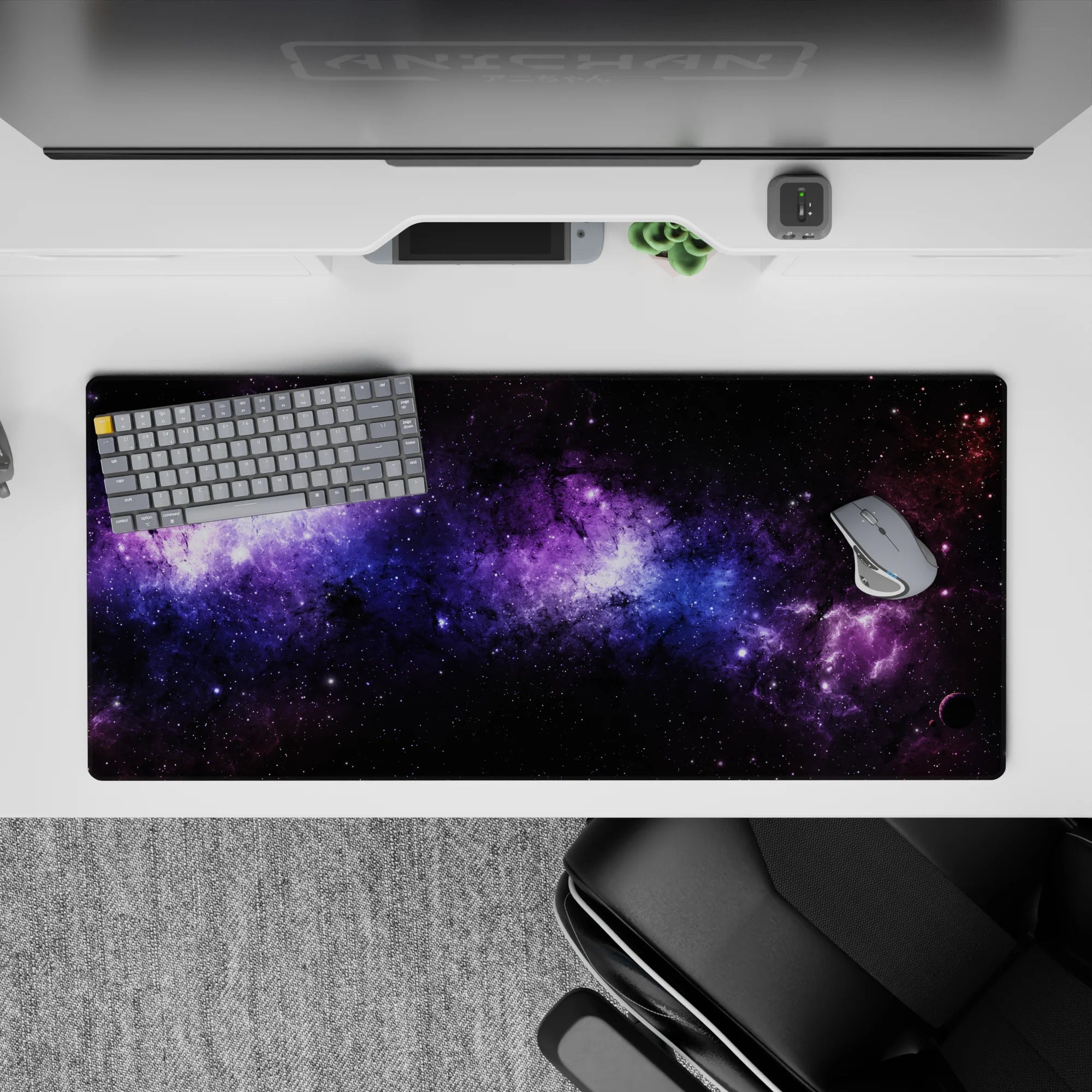 Galaxy-themed desk pad 36x16 inches with purple and blue nebula design, smooth surface for stylish workspace.