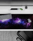 Galaxy-themed desk pad 36x16 inches with purple and blue nebula design, smooth surface for stylish workspace.