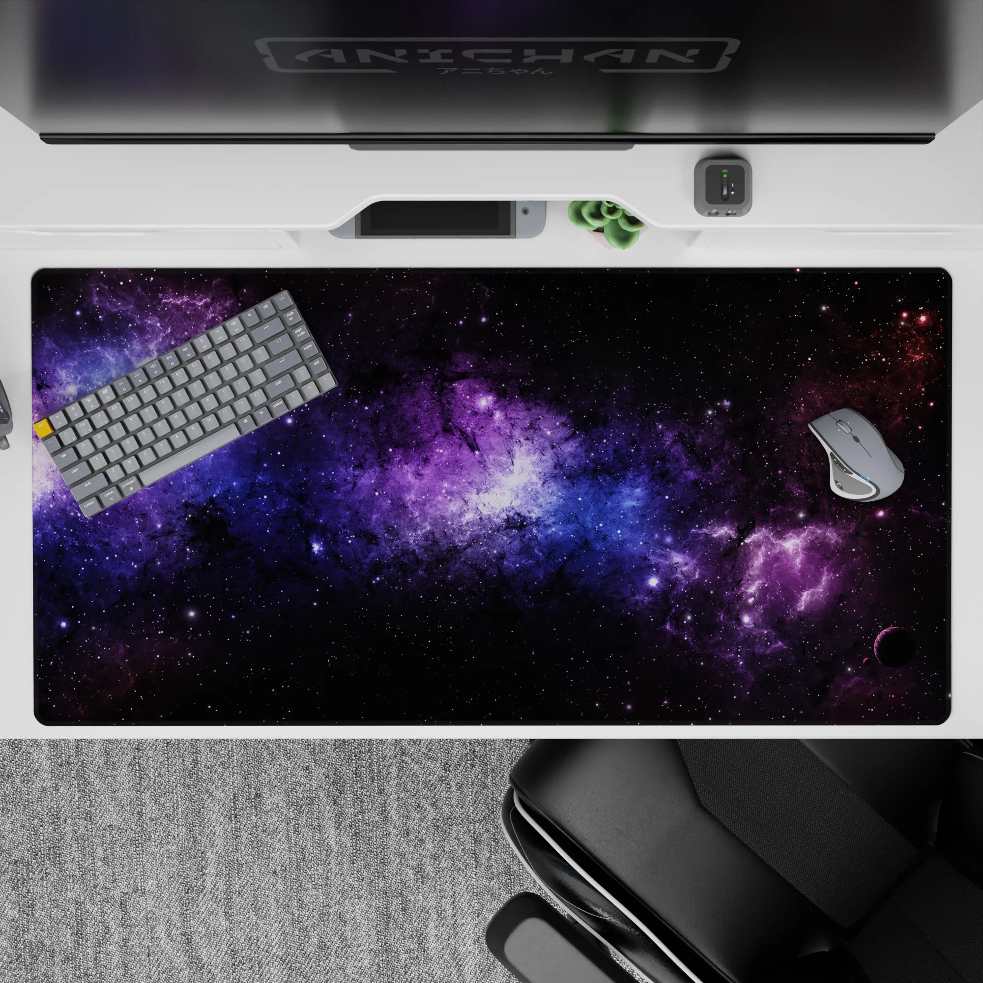 Galaxy-inspired desk pad 40x20 inches with black nebula clouds, violet haze, and blue stardust design.
