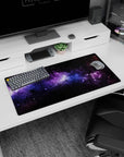 Galaxy inspired desk mouse pad with black, violet, and blue nebula design, size 32x16 inches.