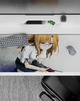 Cozy grayscale tile anime desk pad 36x16 inches with warm tones and a soft violet shine on glasses.