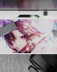 Shinobu from Demon Slayer on a 40x20 inch anime desk pad with violet eyes and butterflies, creating a magical workspace.