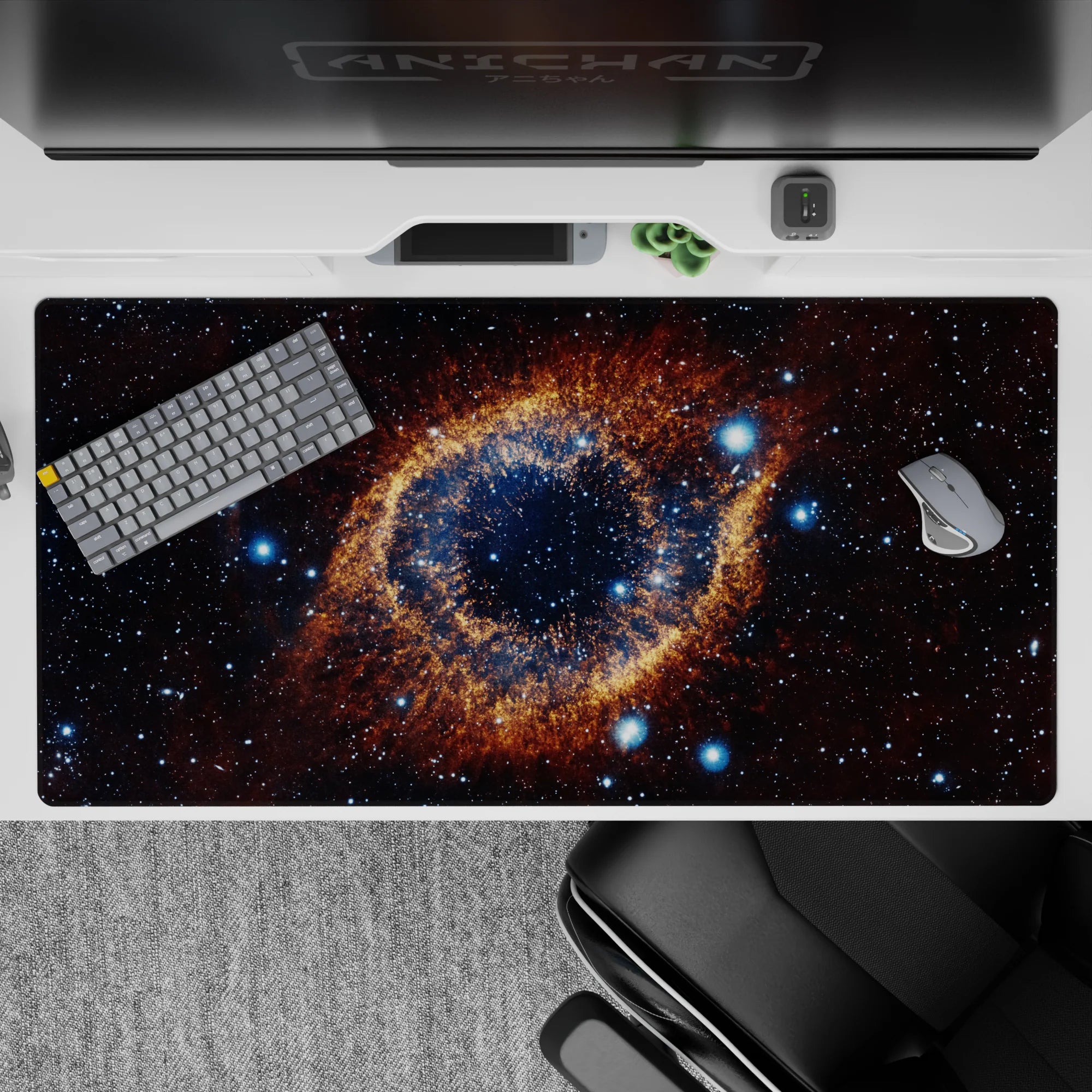 Galaxy themed desk pad 40x20 inches with starry swirl design, amber ring accent, and dark clean backdrop.