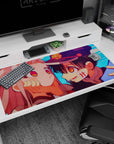40x20 inches desk pad showing grinning cap-wearing boy leaning in, hands on pink-haired girl's cheeks.