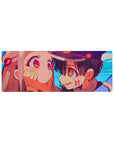 Anime mouse pad 32x12 inches with close-up boy in school cap cupping pink-haired girl's cheeks.