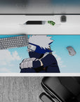 Kakashi Hatake Naruto anime desk pad, 36x16 inches, featuring the iconic silver-haired character under a serene blue sky.