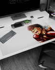 Fierce spiky-haired fighter sprinting forward on anime desk pad 40x20 inches, grinning with red gloves.
