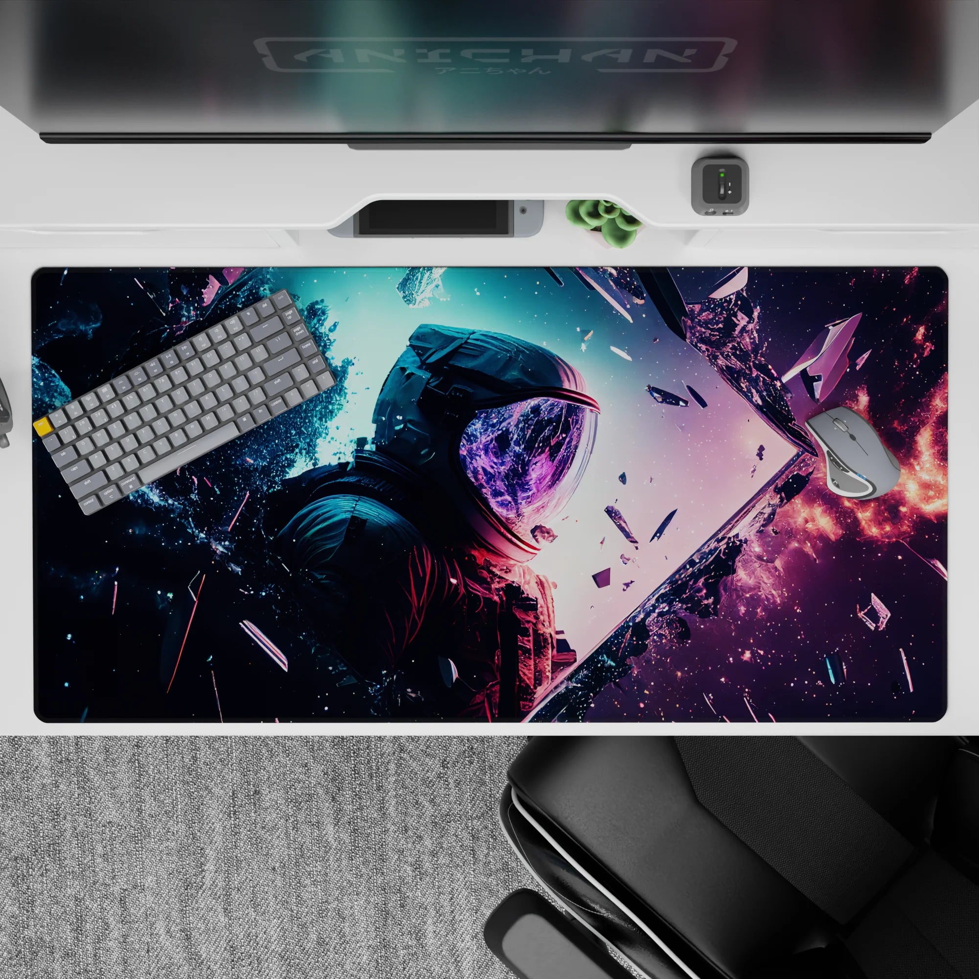 Cosmic desk pad 40x20 inches with nebula blues, purples, coral glow, stars, and astronaut silhouette.