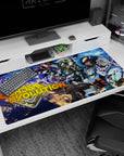 Mobile suits charging through neon space scene on anime desk pad 40x20 inches, white red and gold trim.