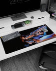 Revy mid-twist with dual pistols and sharp grin on anime desk pad 36x16 inches, glossy highlights.