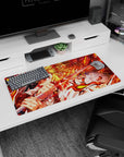 Rengoku from Demon Slayer on a 32x16 inch anime mouse pad, his fiery katana ablaze in red and gold, exuding dynamic energy.