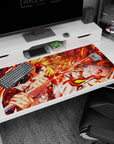 Rengoku from Demon Slayer on a 40x20 inch anime desk pad, engulfed in fiery reds and golds, emanating dynamic energy.