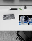 Moody black-and-white anime mouse pad 14x10 inches with icy planet glow and blue paint-splash accents.