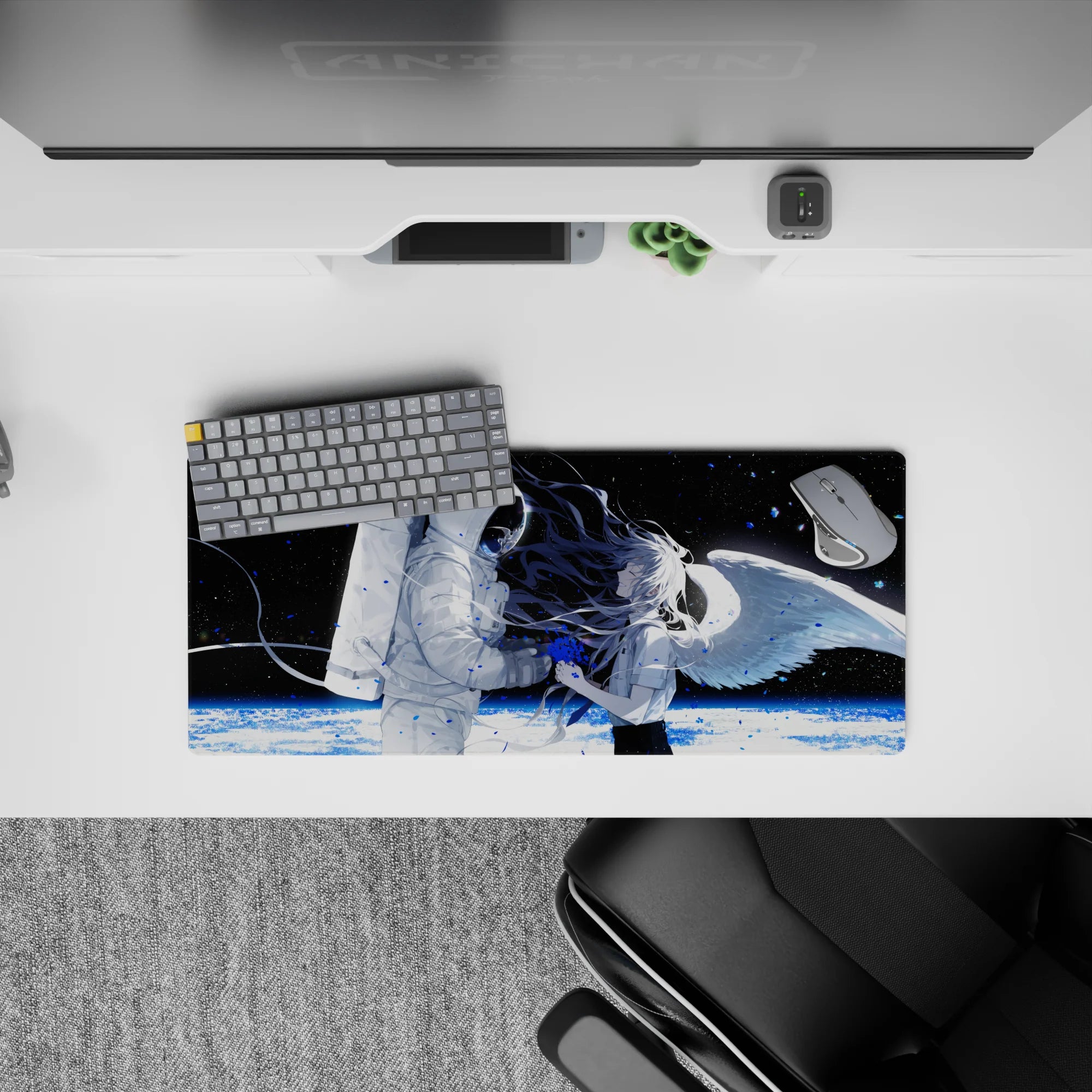 Moody black space anime girl mouse pad 28x12 inches with icy planet glow and blue paint-splash accents.