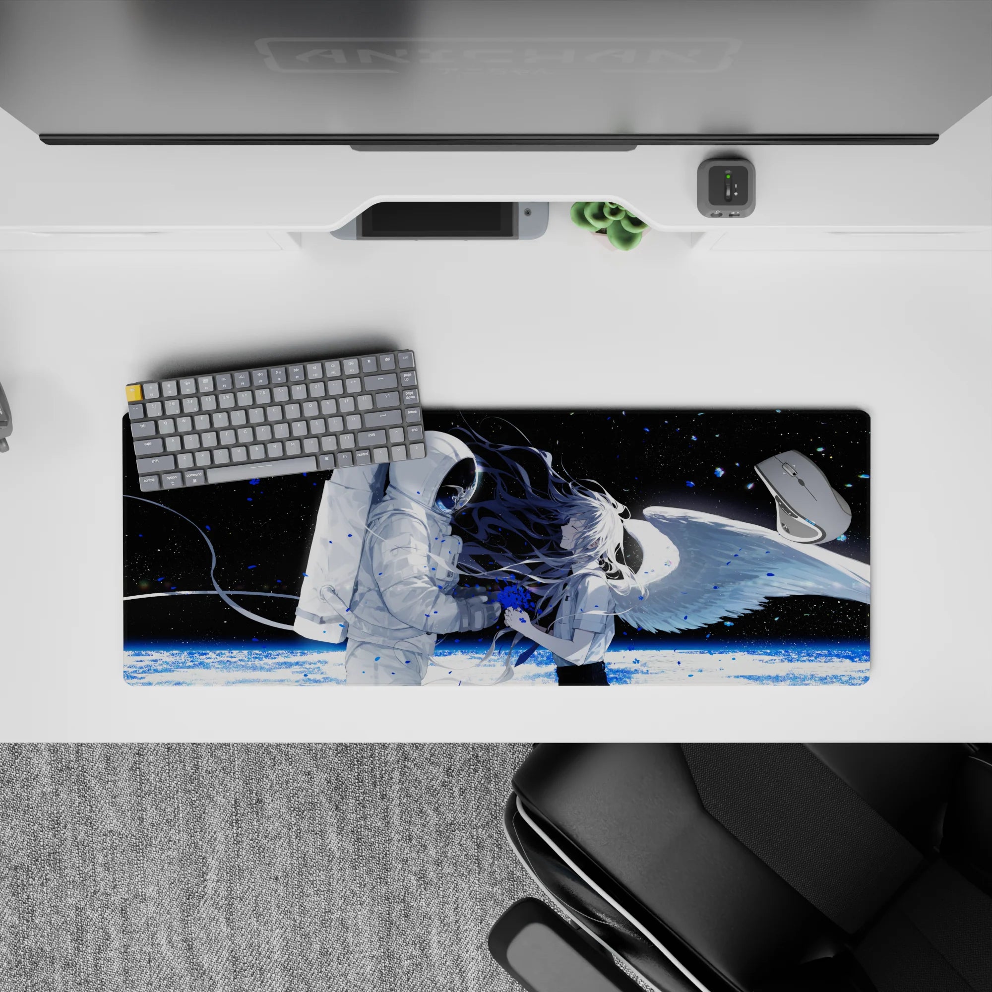 32x12 inches anime desk mat in black space with white astronaut, blue paint splashes, and icy planet glow.