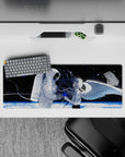 32x12 inches anime desk mat in black space with white astronaut, blue paint splashes, and icy planet glow.