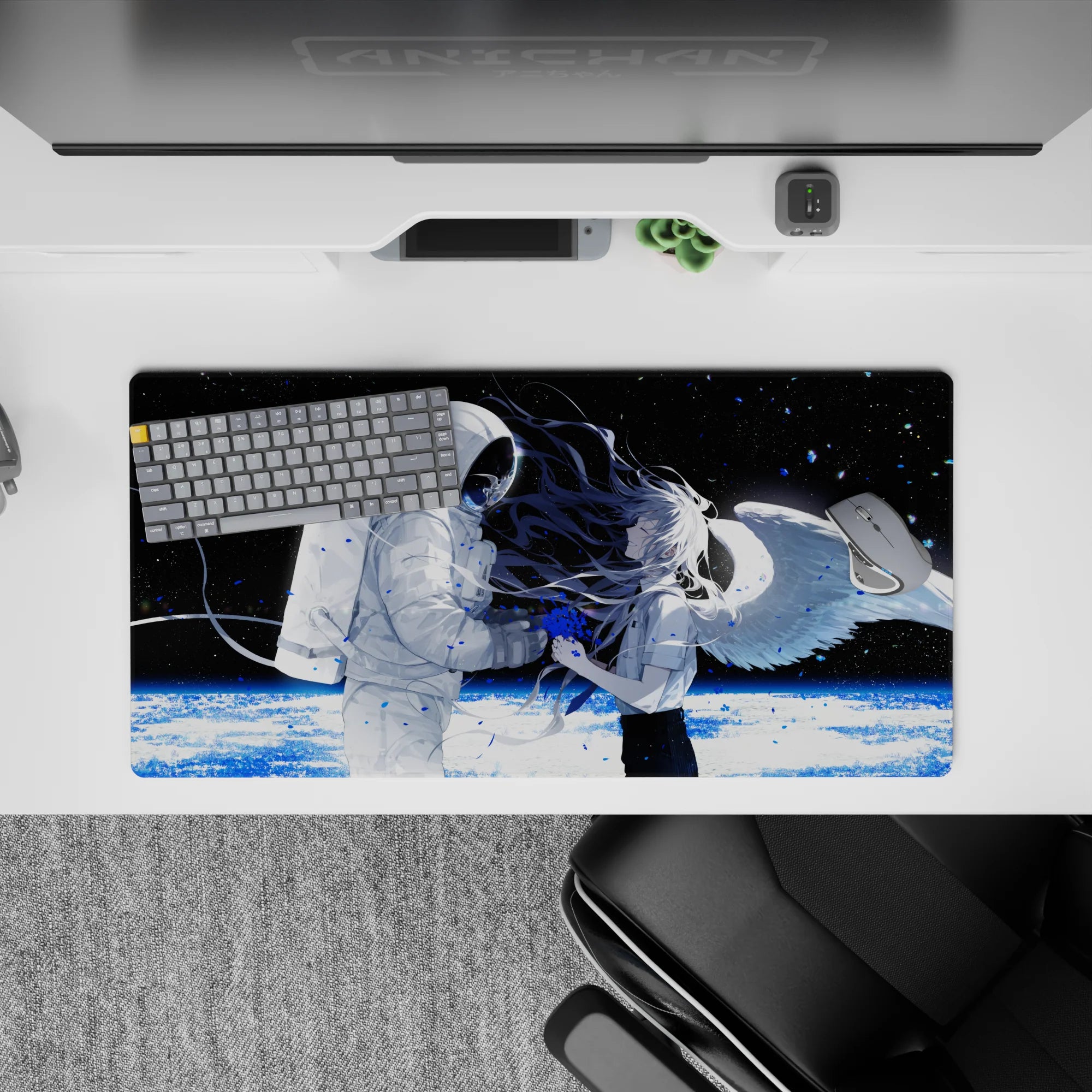 Moody black space anime mouse pad 32x16 inches with icy planet glow and blue paint-splash accents.