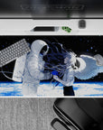 Moody black-and-white anime desk pad with blue paint-splash accents and icy planet glow, 40x20 inches.