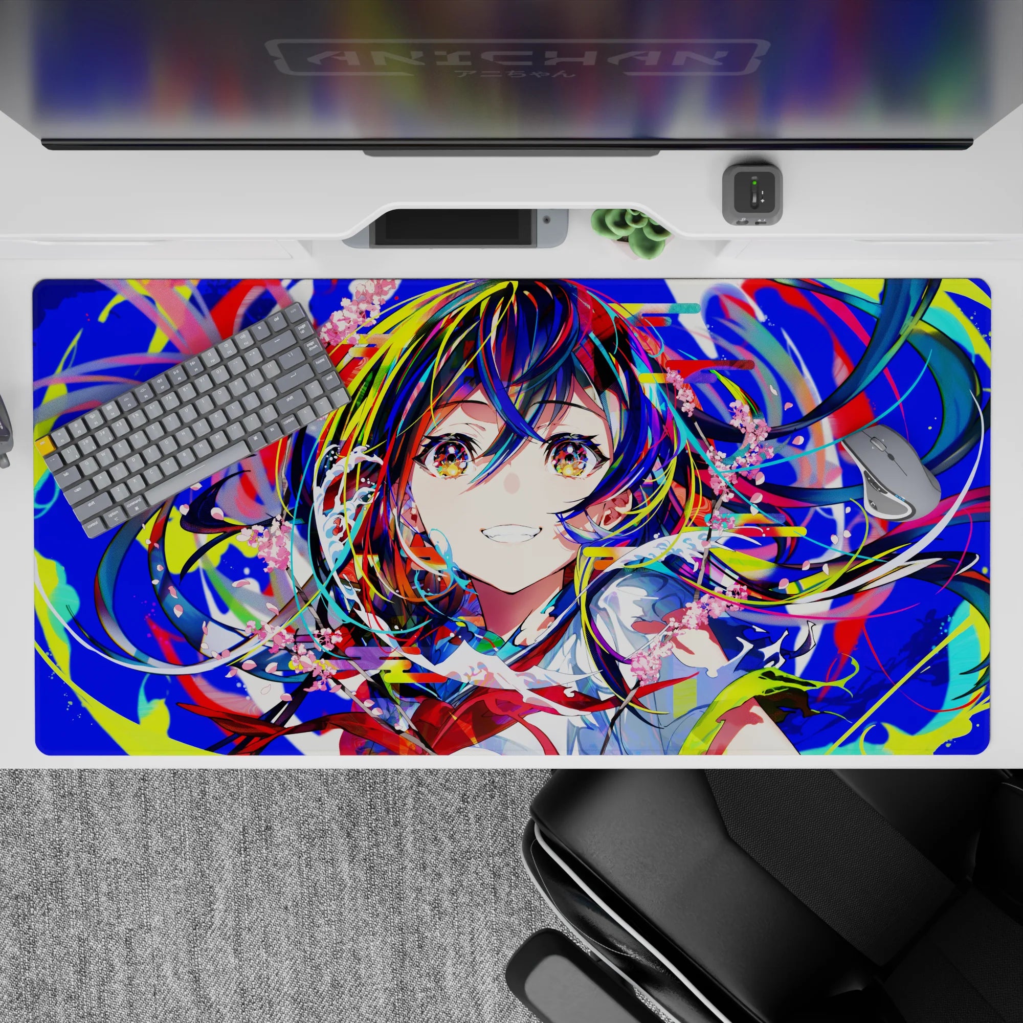 Vibrant 40x20 inches anime desk pad in neon blues, hot reds, lime splashes, and candy-pink petals.