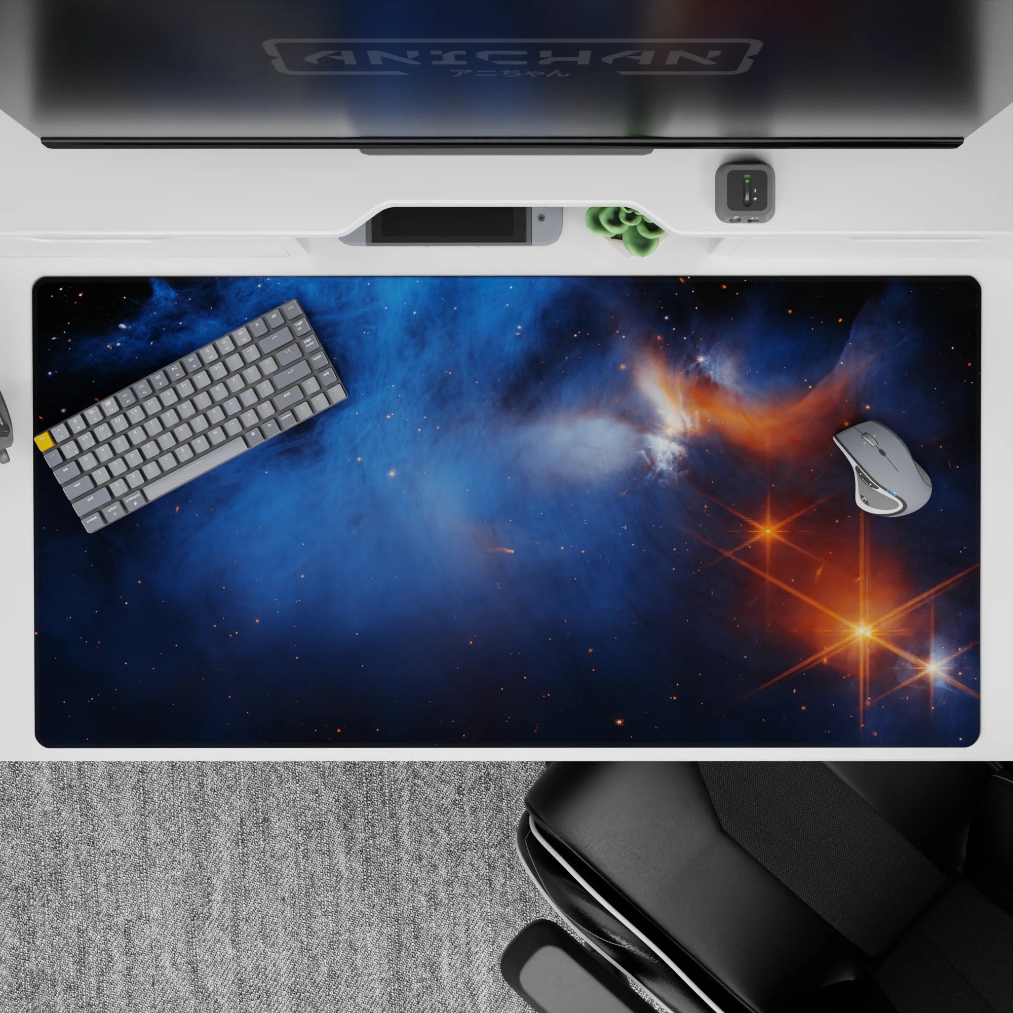 Galaxy-themed desk pad 40x20 inches with smoky blue nebula design, tiny stars, and warm orange flare accents.