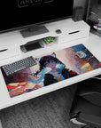 36x16 inches desk pad showing wide-eyed cat-ear girl in oversized hoodie, teal-tipped waves, city blocks behind.