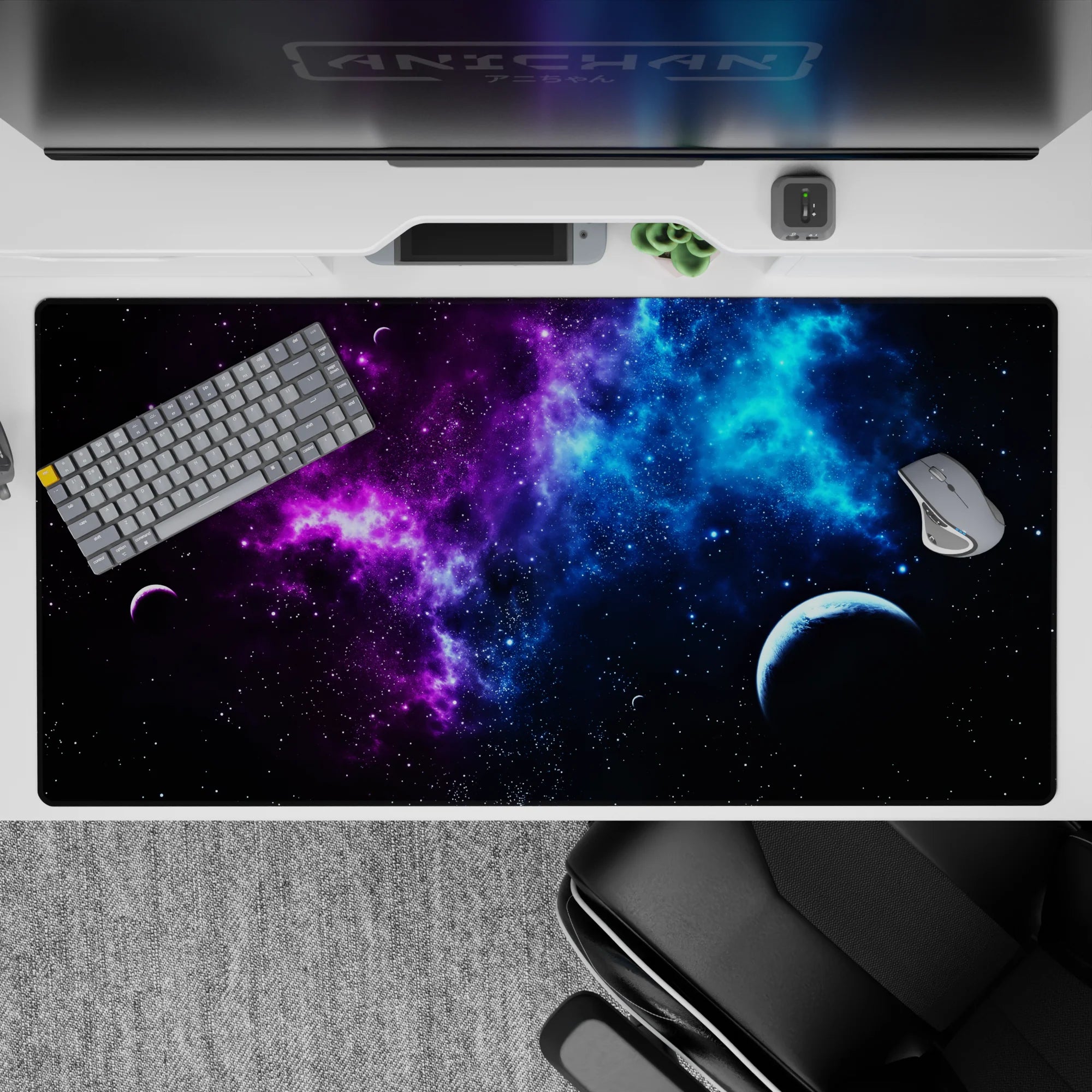 Galaxy print desk pad 40x20 inches with deep violet and electric blue tones, featuring stars and a small planet.