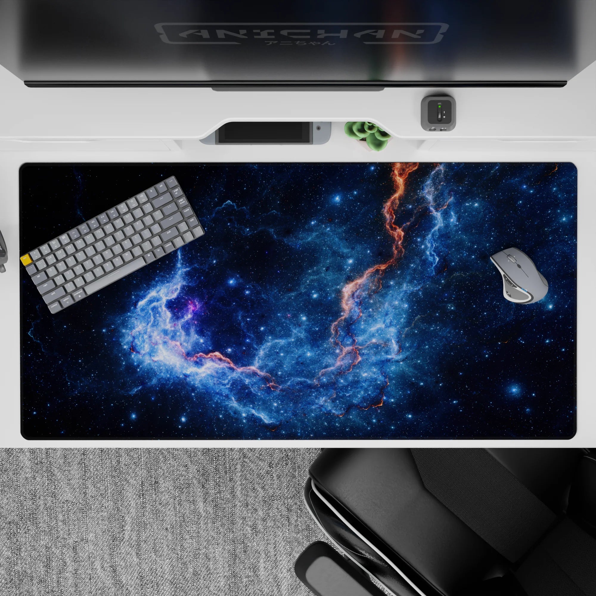 Cosmic-themed desk pad 40x20 inches with deep midnight blue space design, glowing orange accents, and star details.