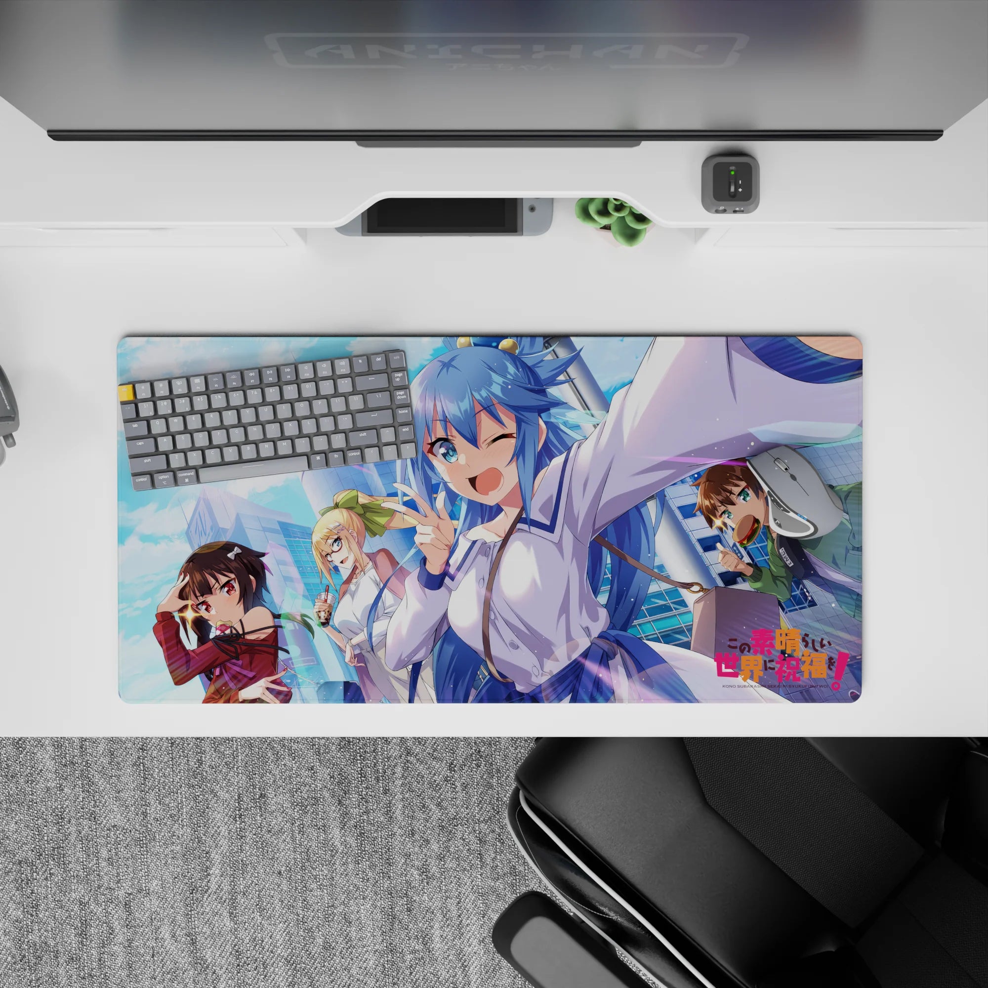 KonoSuba anime mouse pad 32x16 inches featuring Aqua, Megumin, Darkness, and Kazuma with vibrant city and sky background.