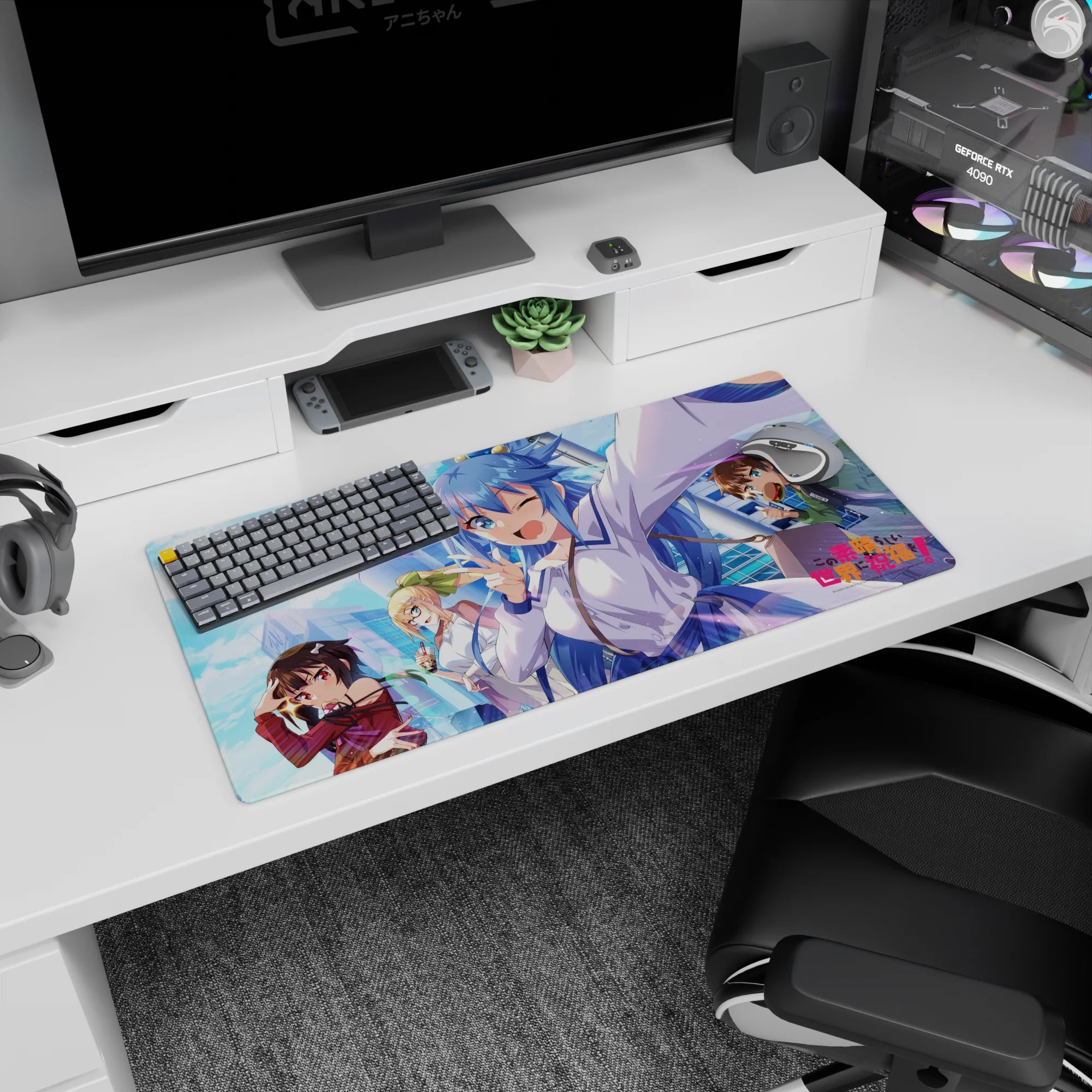 KonoSuba anime mouse pad 32x16 inches featuring Aqua, Megumin, Darkness, and Kazuma with vibrant cityscape backdrop.
