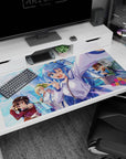 Anime desk pad featuring KonoSuba characters Aqua, Megumin, Darkness, and Kazuma in vibrant cityscape, 40x20 inches.