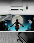 Moody blue neon anime girl desk pad 36x16 inches, rain-slick skyline glow with warm brown accents.