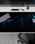 Calming deep space desk pad 40x20 inches in inky black and stormy blue tones with a powerful glow.