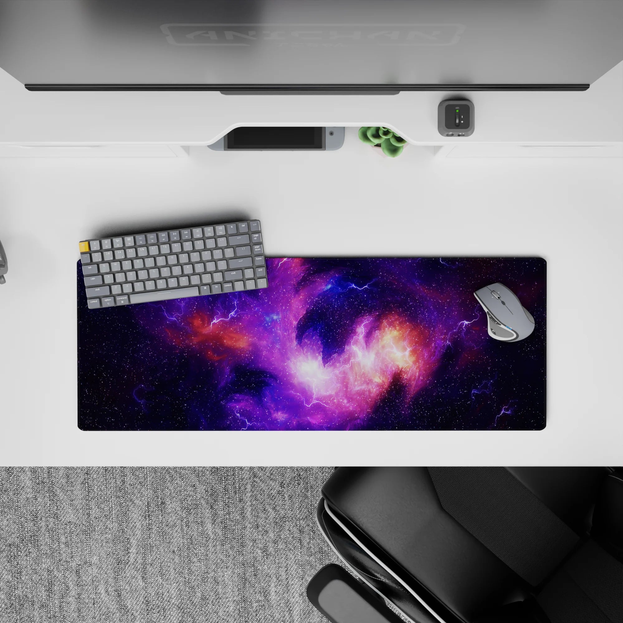 Calming cosmic desk pad 32x12 inches in deep violet, electric lilac, and warm orange nebula glow.