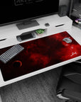 Shadowed planet and starry crimson nebula desk pad 40x20 inches, ink-like clouds across the surface.
