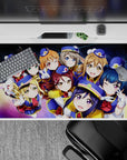 Galaxy swirl anime girl desk pad 40x20 inches in deep space blues with rainbow glow, cheerful vibe.