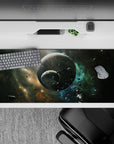 Calming teal nebula desk pad 36x16 inches in smoky black with stardust gold accents, night-sky mood.