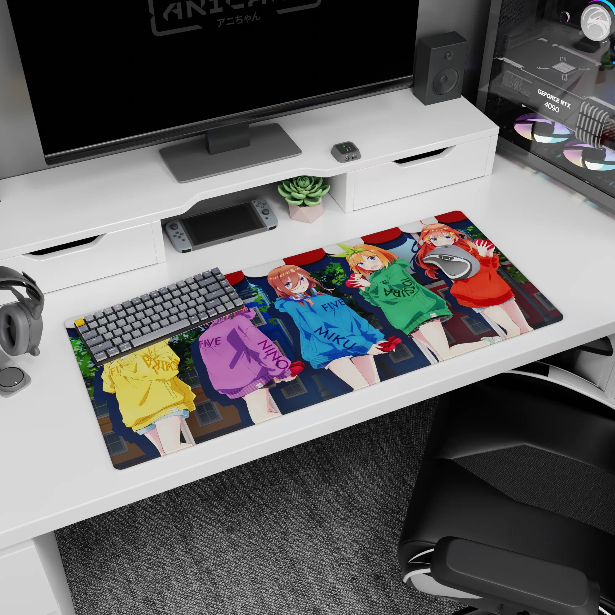 Anime desk pad 36x16 inches showing five bright girls hugging red hearts, playful lettering on hoodies.
