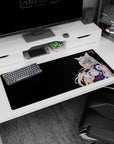 Smiling catgirl maid sprawled across desk pad 36x16 inches, blue and gold eyes, lavender bow, florals.