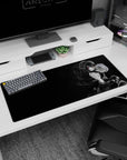 Anime girl desk pad 36x16 inches showing a finger-to-lips shh pose, ribbons, and flowing twin tails.