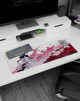Anime girl mouse pad 32x12 inches showing gloved blonde posing before pink blossoms and drifting paper.
