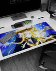Blonde knight with icy-blue eyes holds a radiant sword on a 40x20 inches anime desk pad.