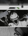Monochrome anime desk pad 40x20 inches, ink-black horror-cute vibe with pale wide-eyed girl.
