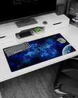 Tiny dark void in cloudy nebula scene mouse pad 32x16 inches with a glossy planet peeking in corner.