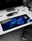 Tiny dark void in swirling nebula desk pad 36x16 inches, with a glossy quiet planet peeking in.