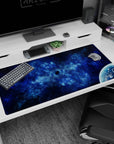Tiny dark void and distant planet scene desk pad 40x20 inches, swirling nebula clouds across a blue galaxy.