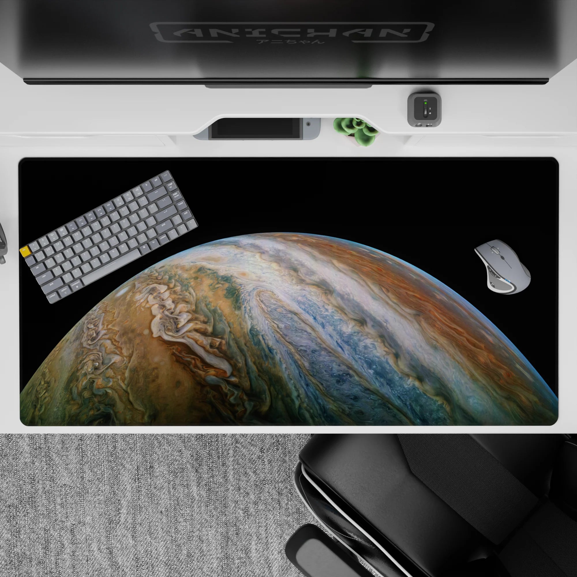 Cosmic themed desk pad 40x20 inches with swirling planet design in blues and tans on a deep black background.