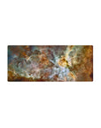 Cosmic nebula mouse pad with teal, gold, and white swirls, measuring 28x12 inches, ideal for stylish desks.