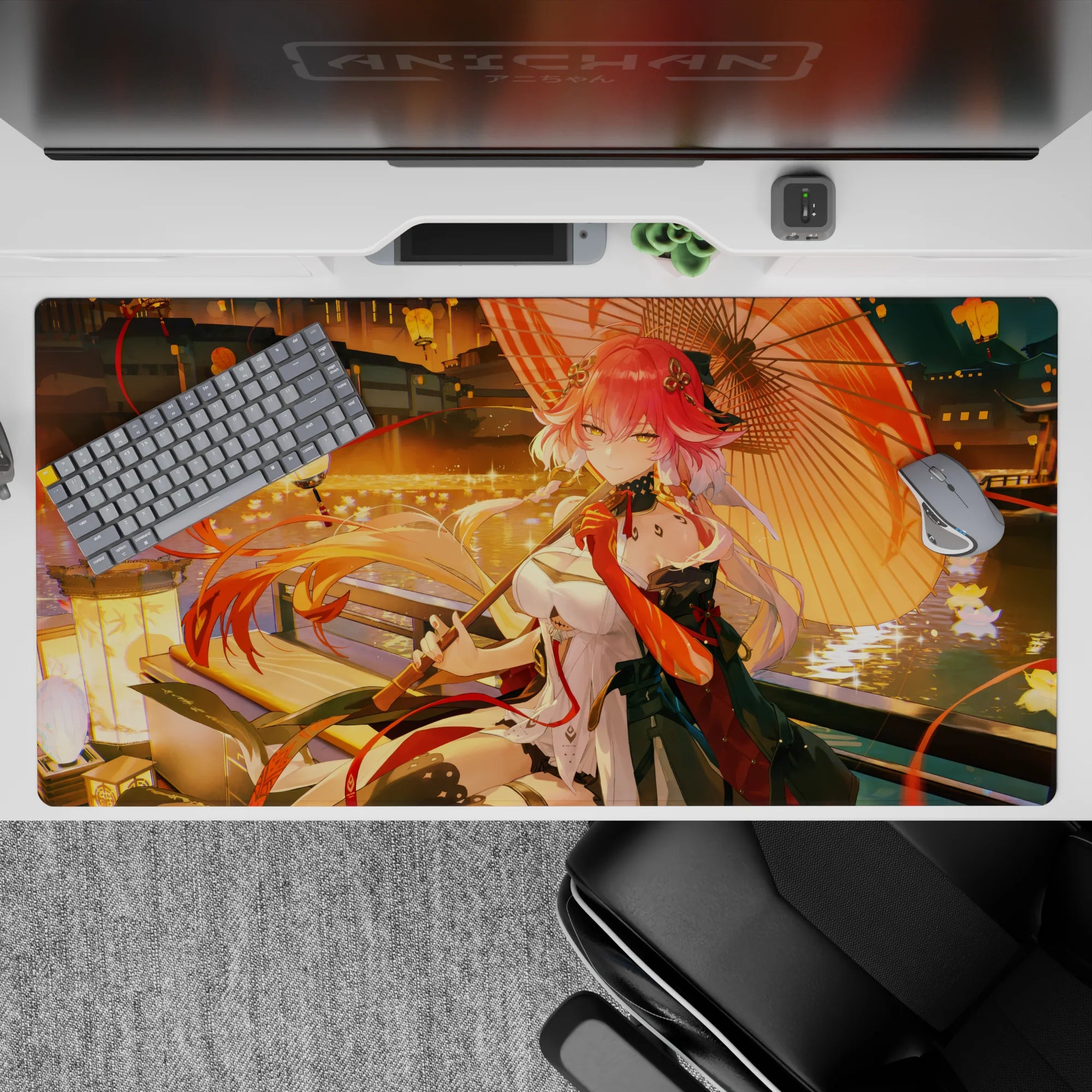 Cozy lantern glow desk pad 40x20 inches in gold, coral, and red with rippling water reflections.