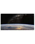 Space-themed mouse pad 32x16 inches with starry sky, dusty galaxy band, and Earth horizon curve.